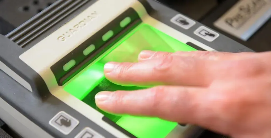 Fingers on a Live Scan fingerprint scanner